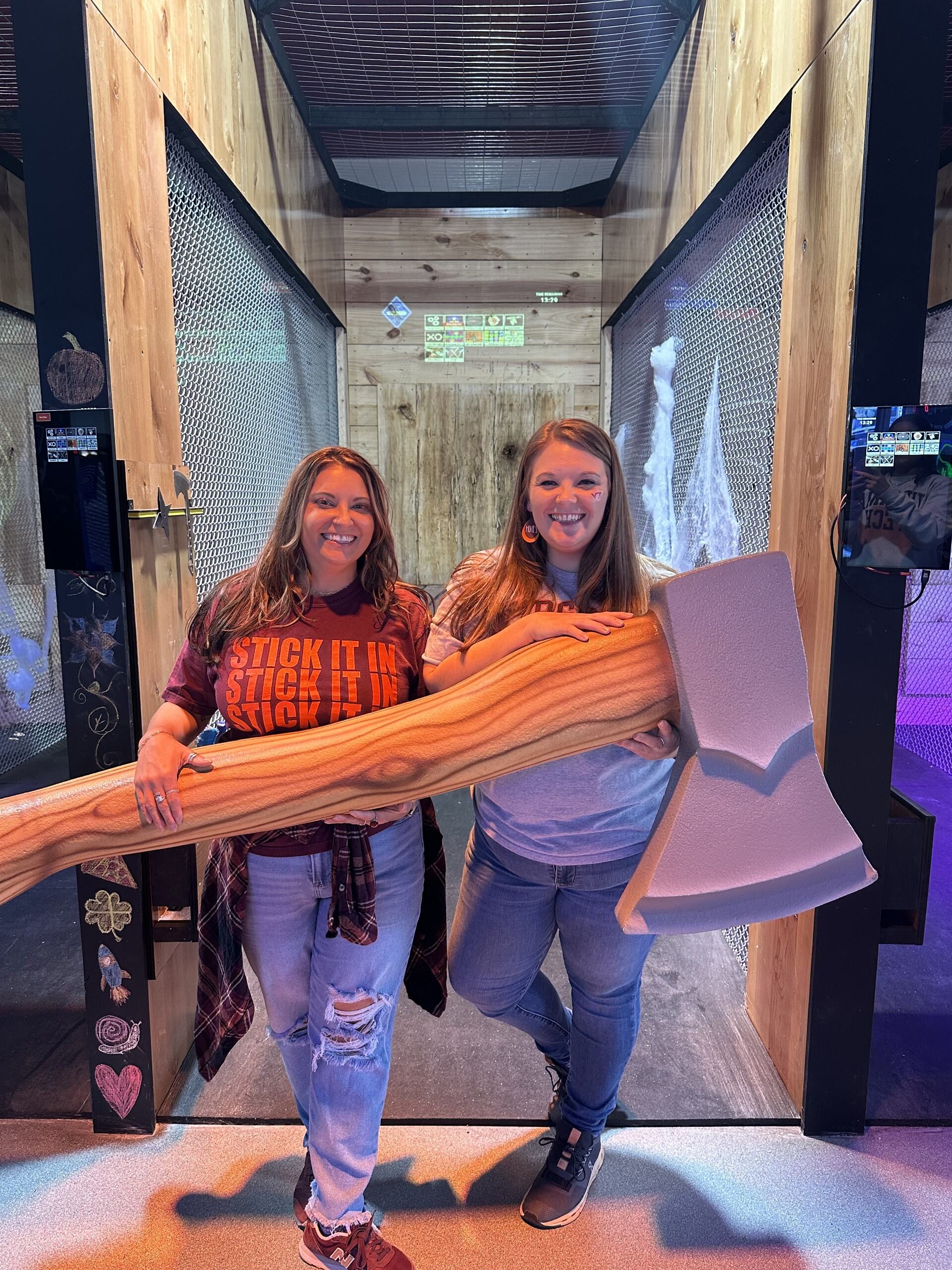 Two guests posing with an oversized novelty axe