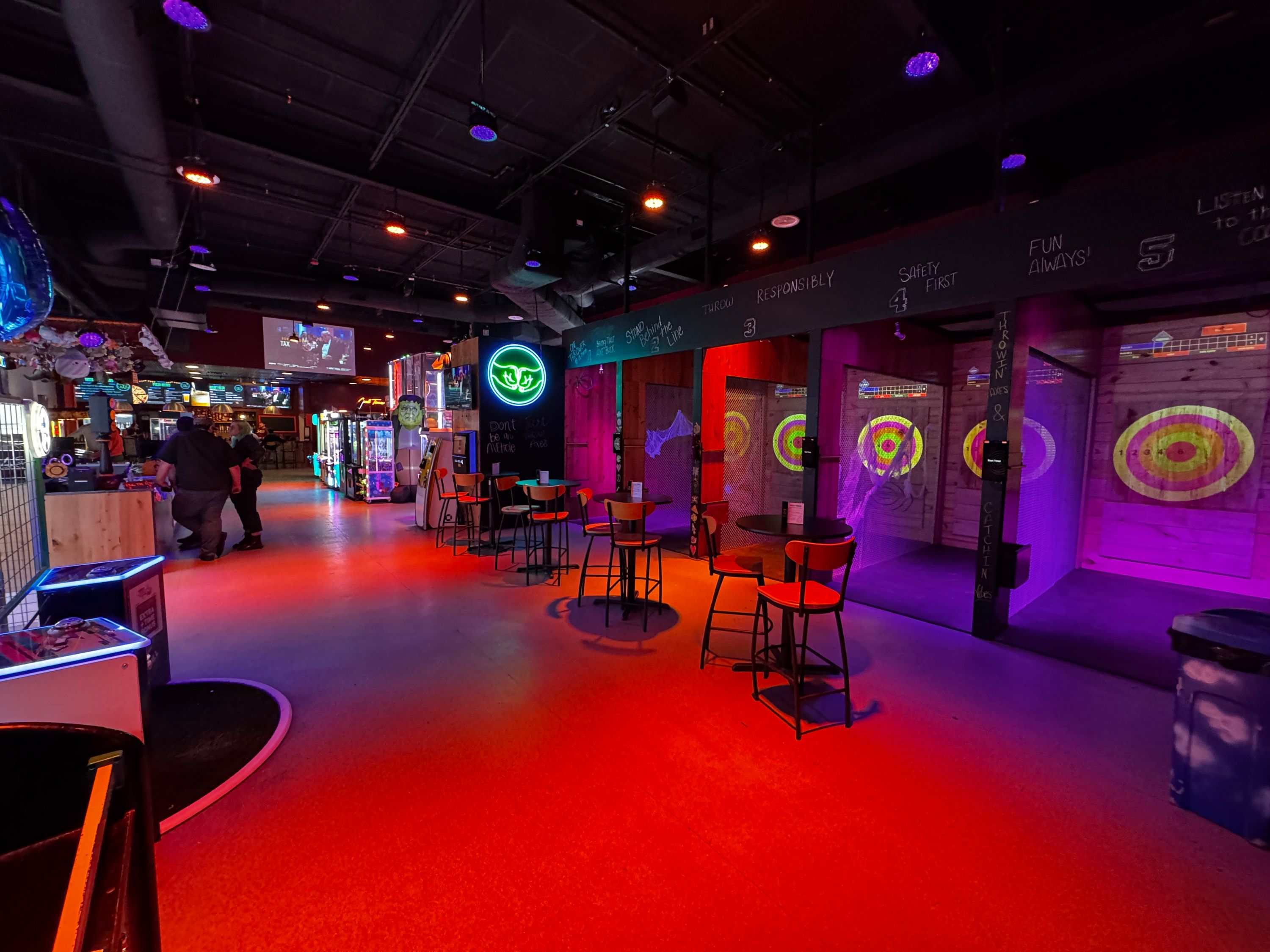 The colorful interior of 540 Social with projected axe lanes
